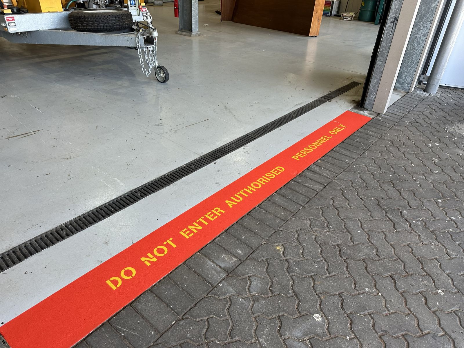 Industrial floor safety marking beside a warehouse entrance